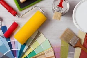 Paint brushes and color palette placed on a table